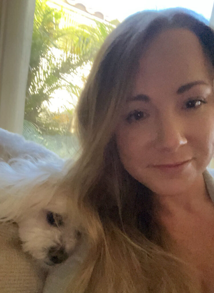 a woman taking a selfie with a cat